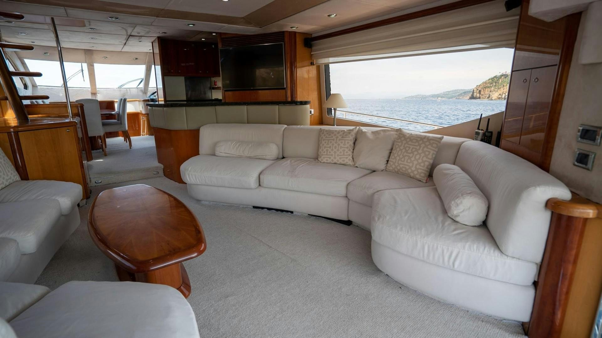 a living room with a couch and a window aboard LUCKY Yacht for Sale