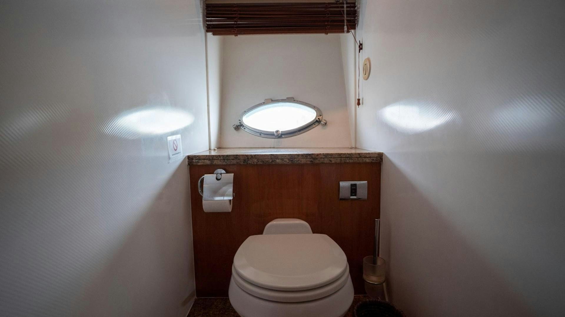 a bathroom with a toilet and a mirror aboard LUCKY Yacht for Sale