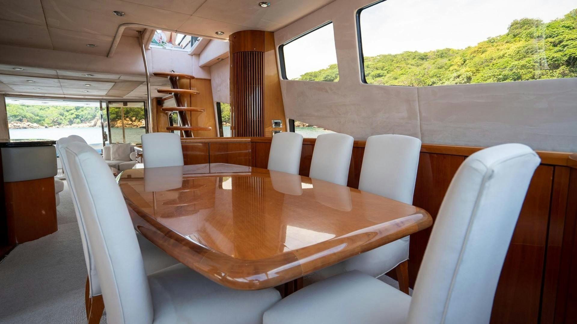 a table with chairs around it aboard LUCKY Yacht for Sale