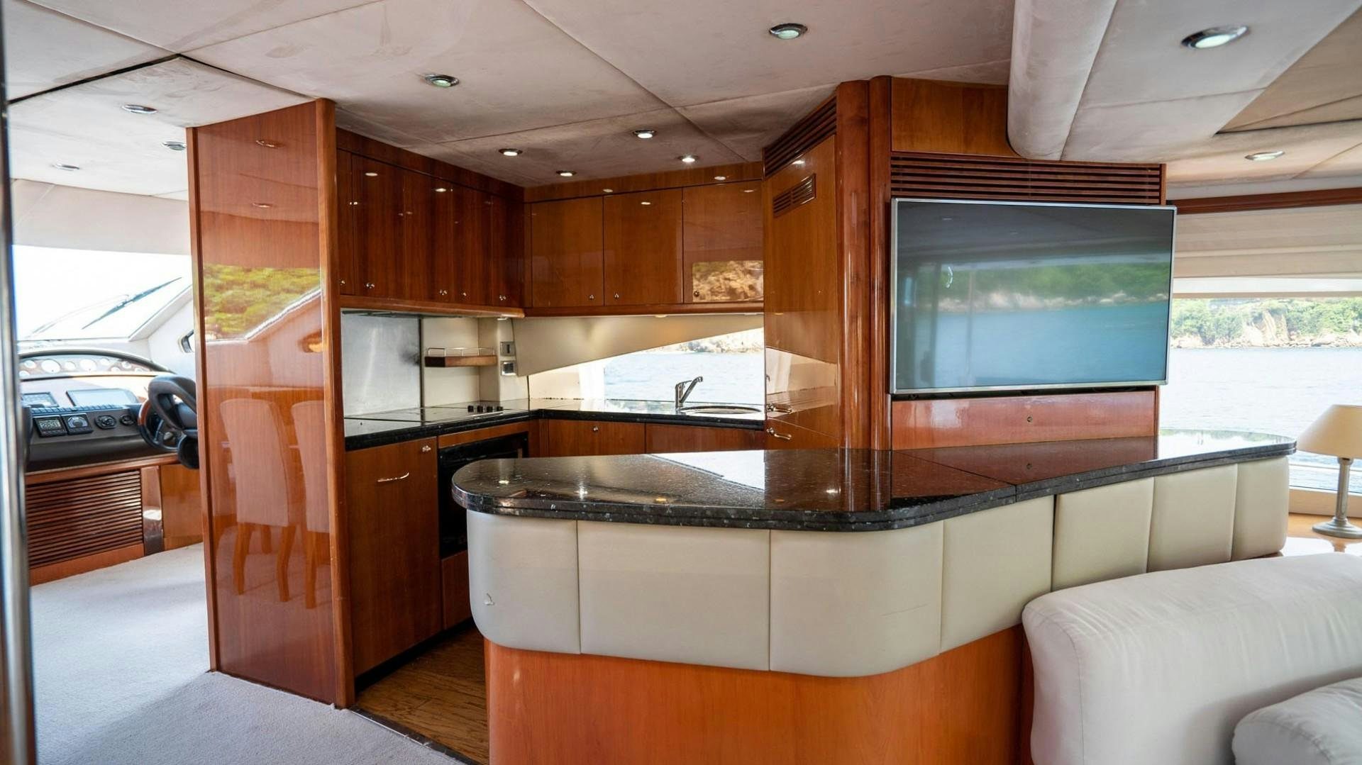 a kitchen with wooden cabinets aboard LUCKY Yacht for Sale