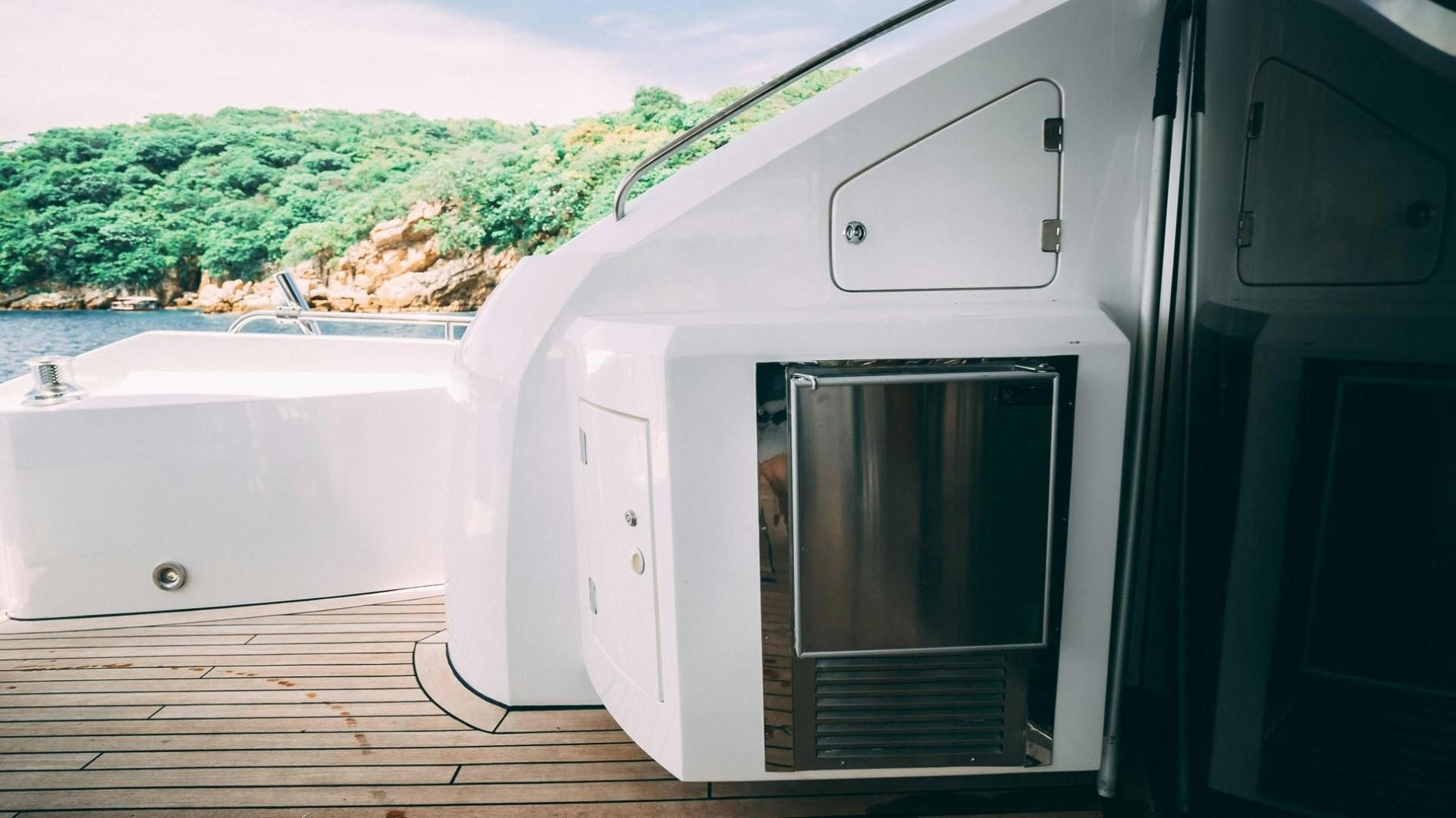 a white rectangular object with a black object on a wooden surface aboard LUCKY Yacht for Sale