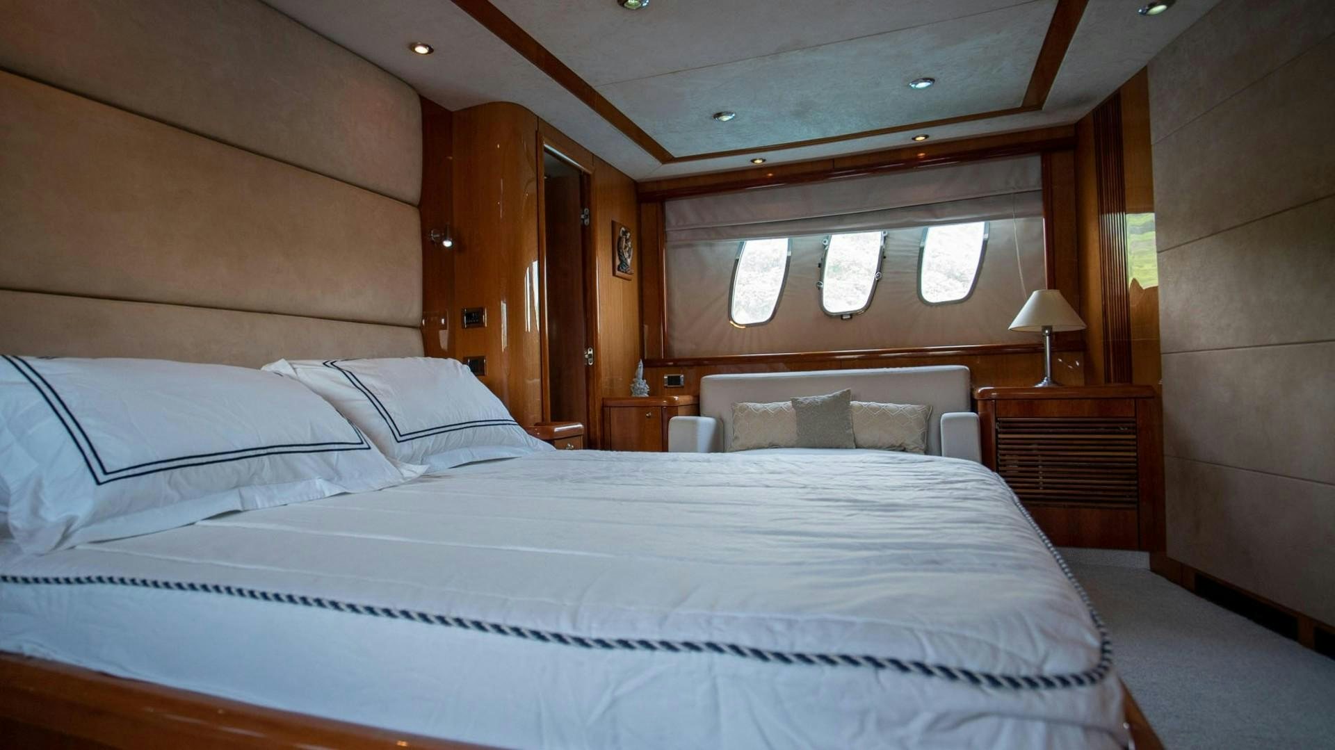 a bed with white sheets aboard LUCKY Yacht for Sale