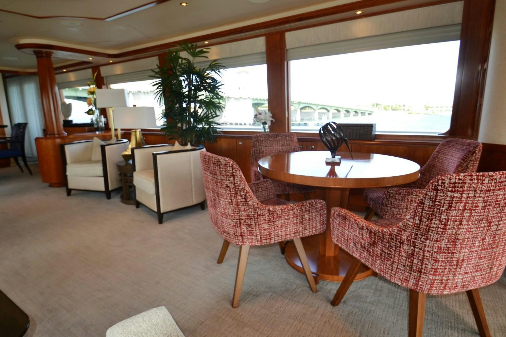 a room with a table and chairs aboard REBELLIOUS Yacht for Sale