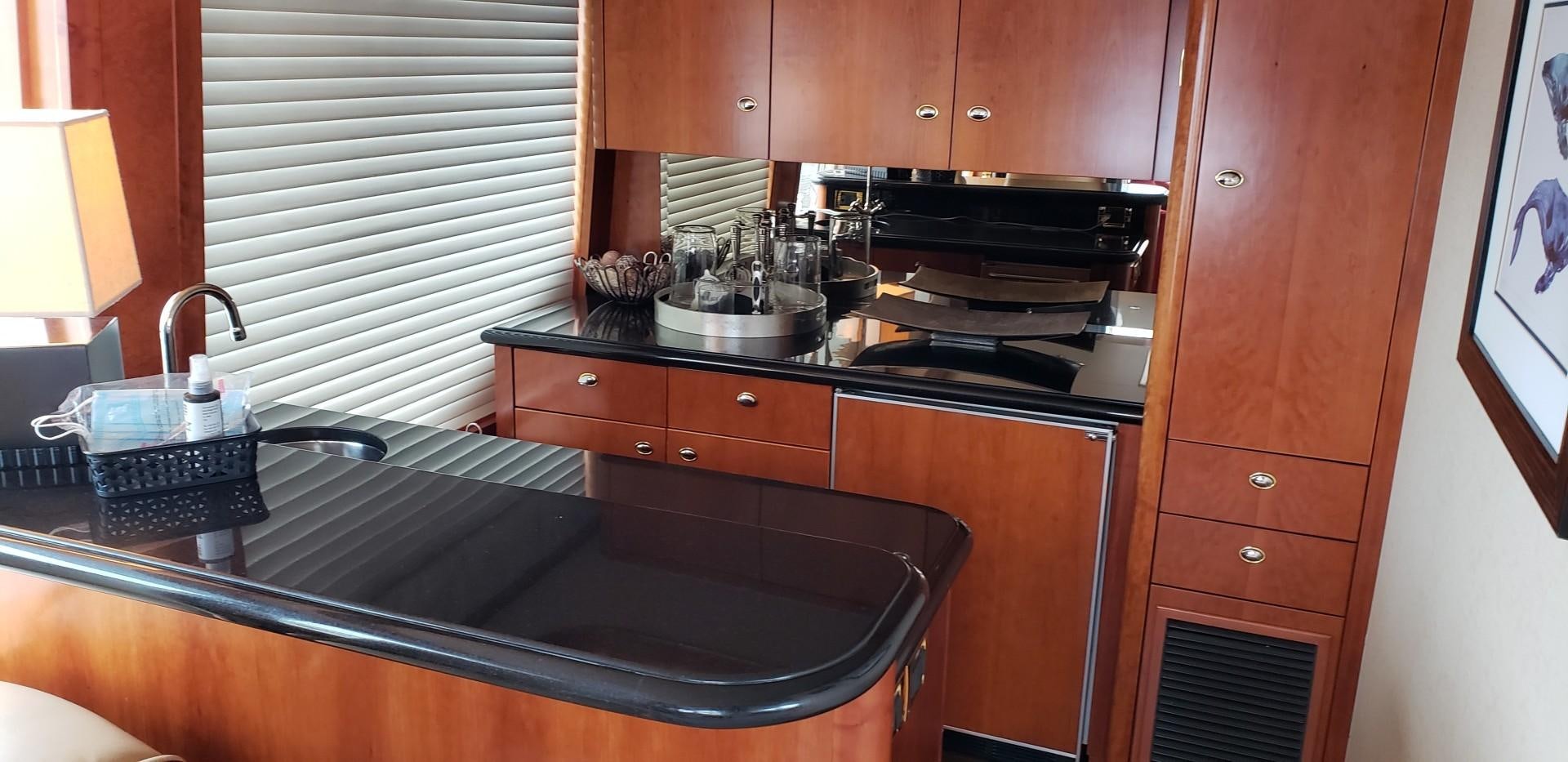 a kitchen with wooden cabinets aboard REBELLIOUS Yacht for Sale