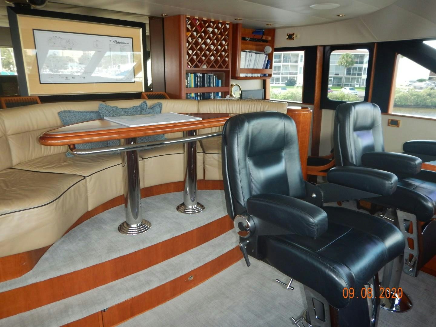 a room with a table and chairs aboard REBELLIOUS Yacht for Sale