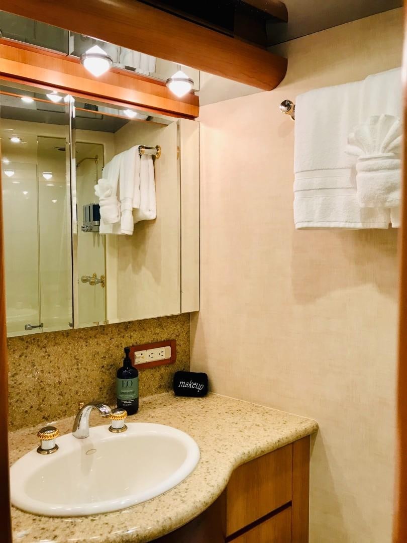 a bathroom with a mirror and a sink aboard EQUINOX X Yacht for Sale