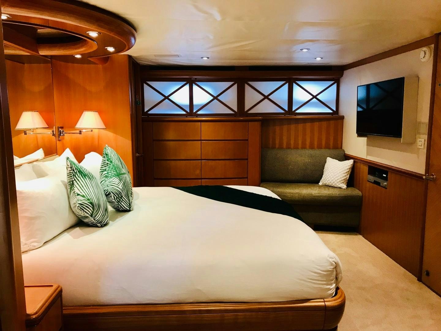 a room with a bed and a couch aboard EQUINOX X Yacht for Sale