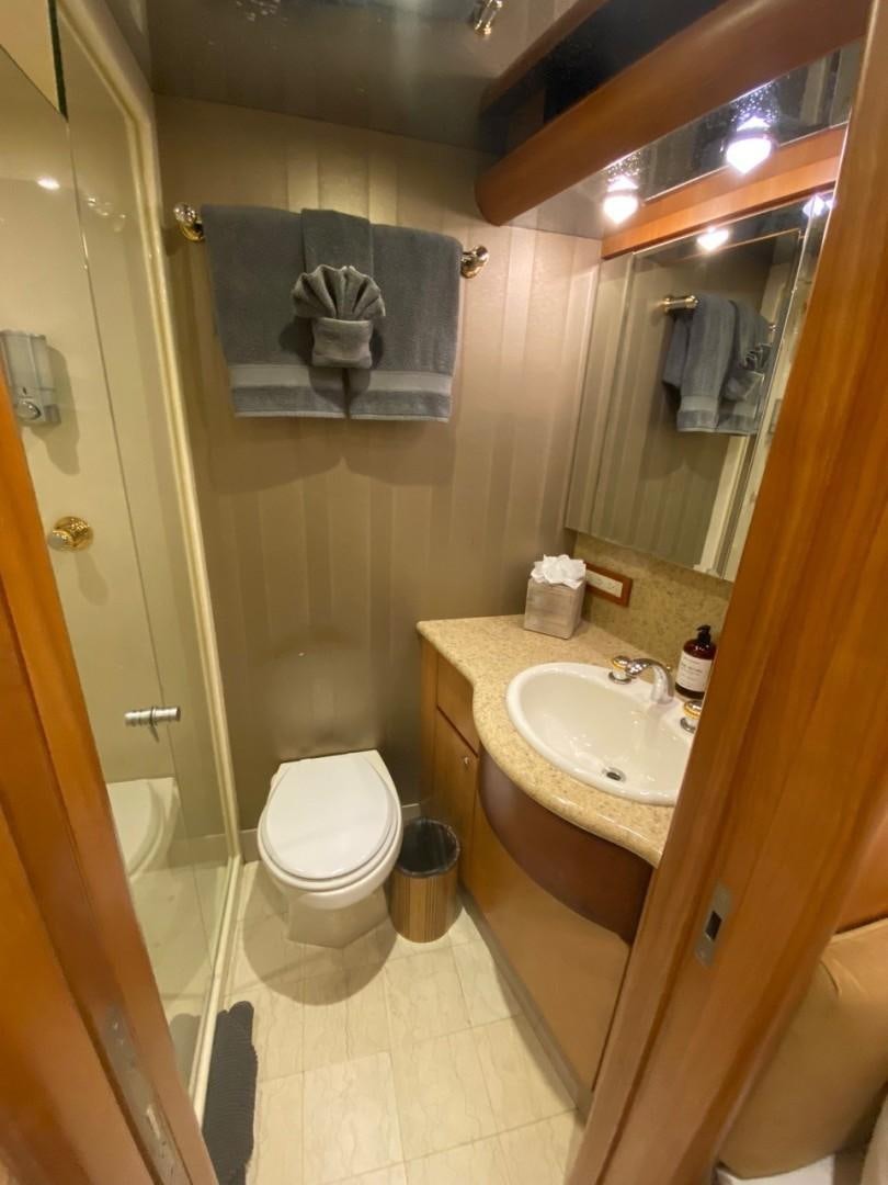 a bathroom with a sink toilet and towels aboard EQUINOX X Yacht for Sale