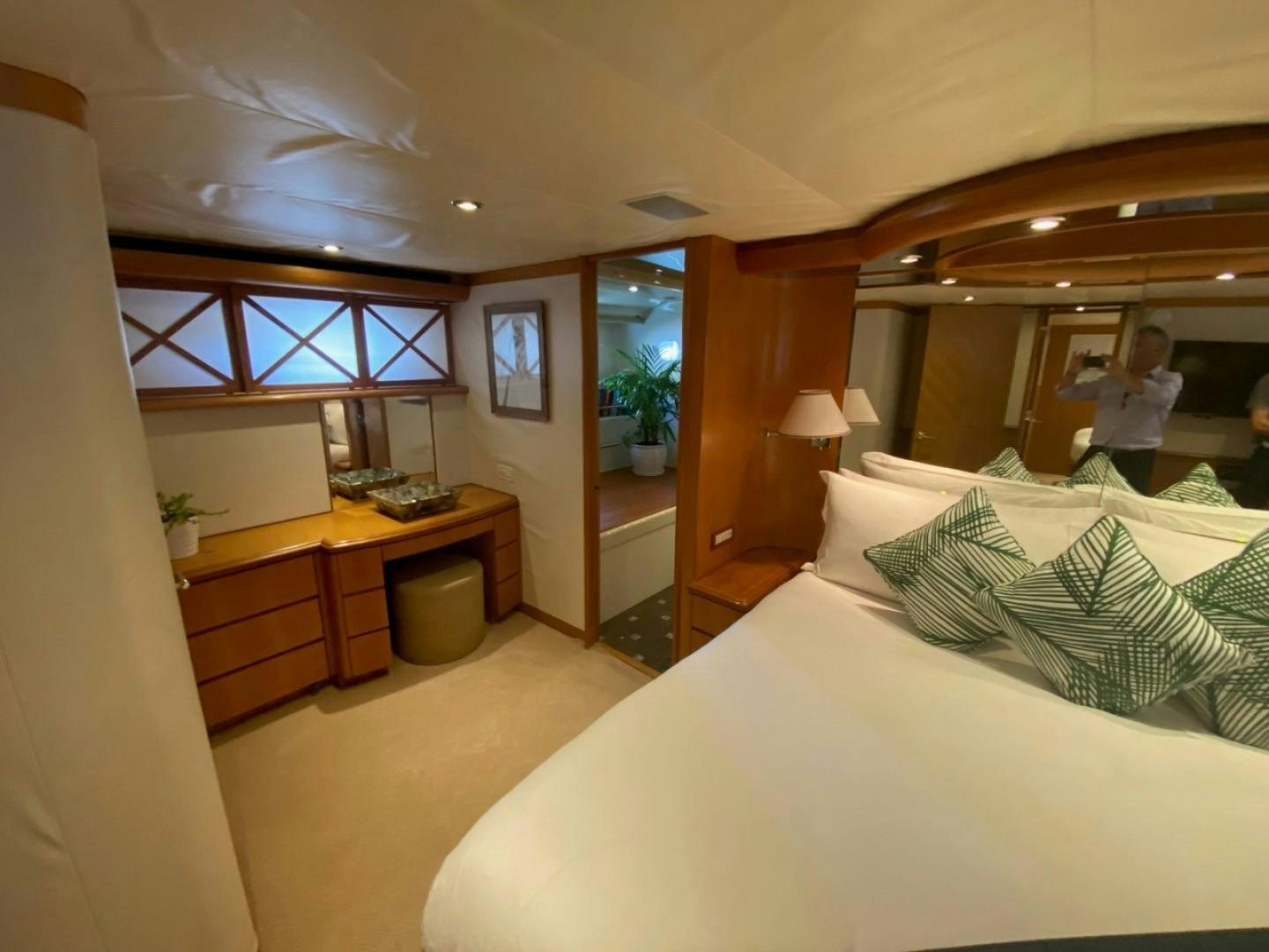 a person sitting on a bed aboard EQUINOX X Yacht for Sale
