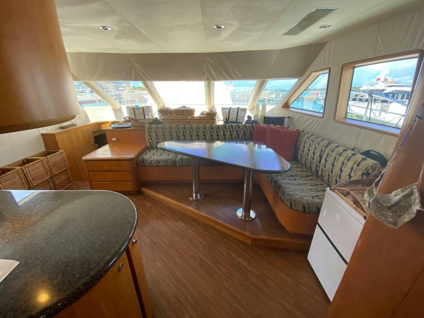 a room with a pool table and couches aboard EQUINOX X Yacht for Sale