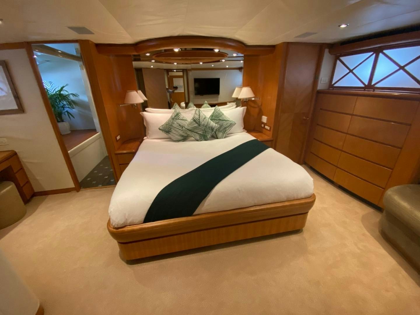 a bedroom with a bed and a mirror aboard EQUINOX X Yacht for Sale