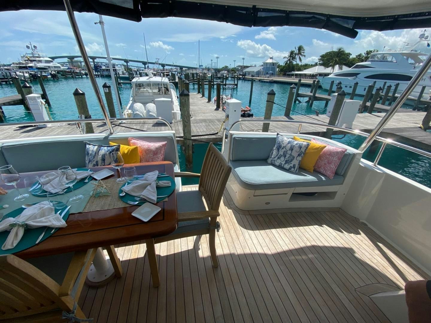 a deck with a view of the water and boats aboard EQUINOX X Yacht for Sale