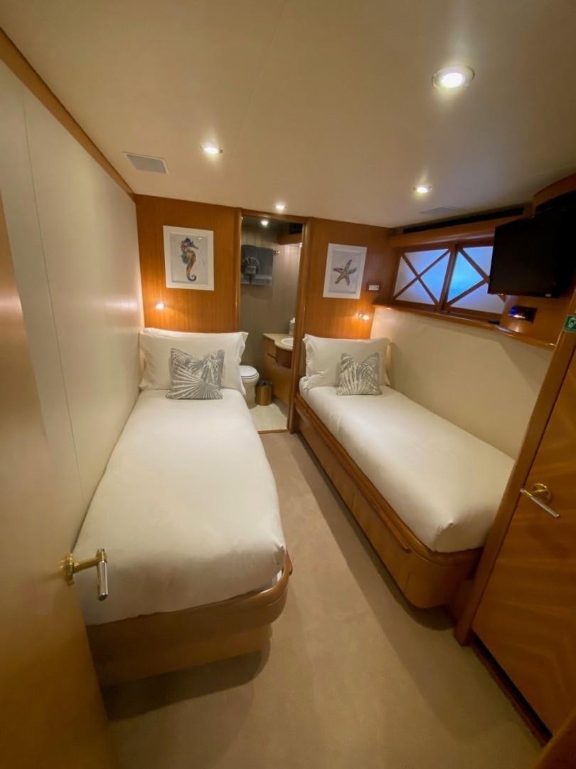 a room with a couple of beds aboard EQUINOX X Yacht for Sale