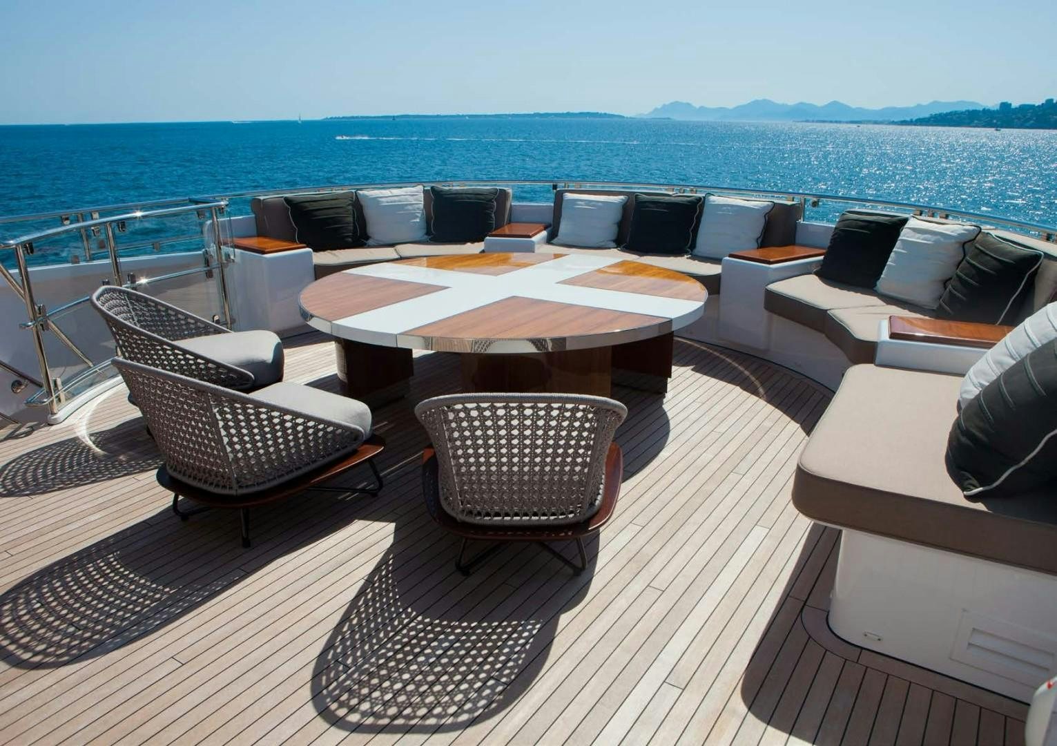 a deck with chairs and a table on it aboard ASYA Yacht for Sale