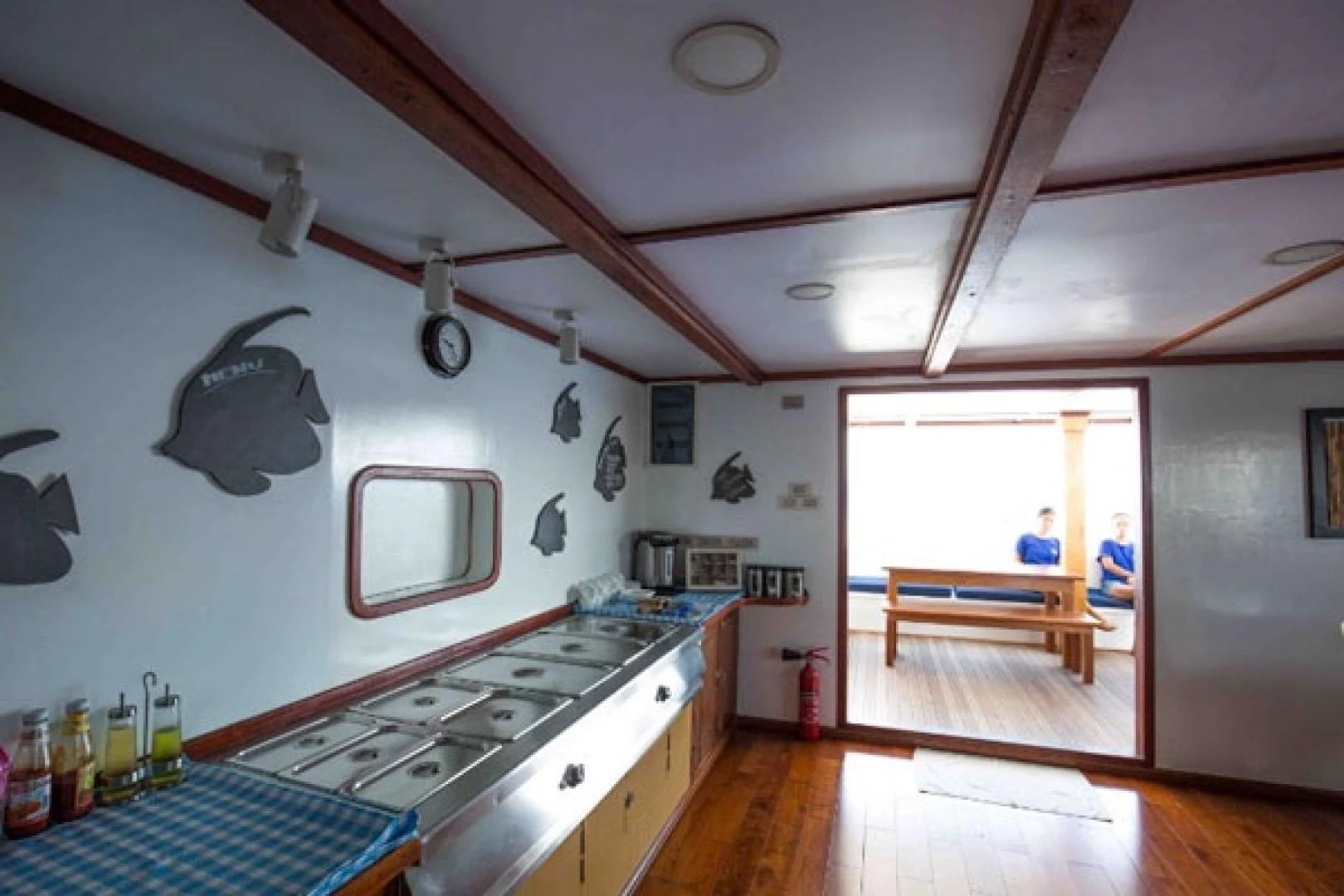 a kitchen with a stove and a table aboard KEANA Yacht for Sale