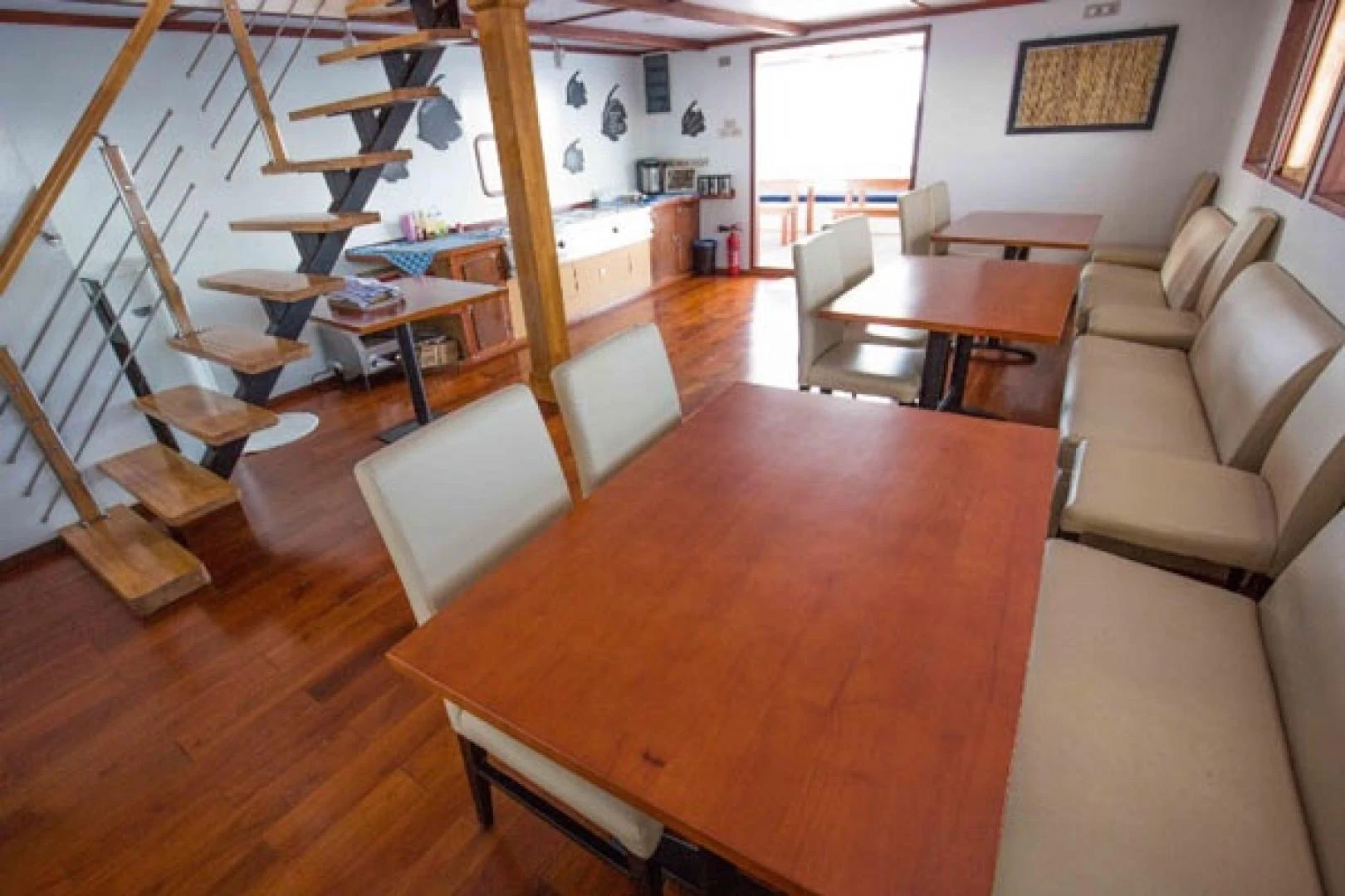 a room with a table and chairs aboard KEANA Yacht for Sale