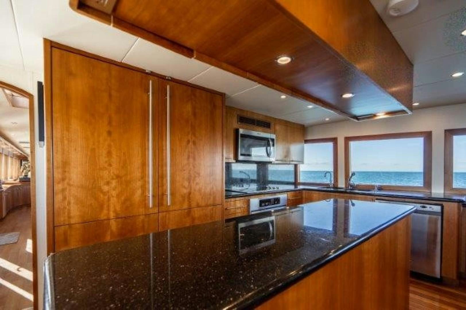 a kitchen with wooden cabinets aboard CENTODUE Yacht for Sale