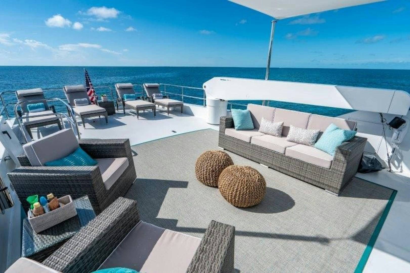 a deck with chairs and a couch aboard CENTODUE Yacht for Sale