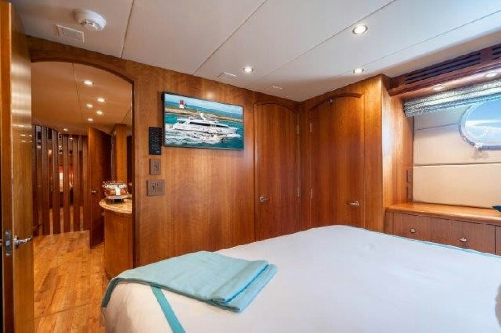a room with a bed and a wood wall aboard CENTODUE Yacht for Sale