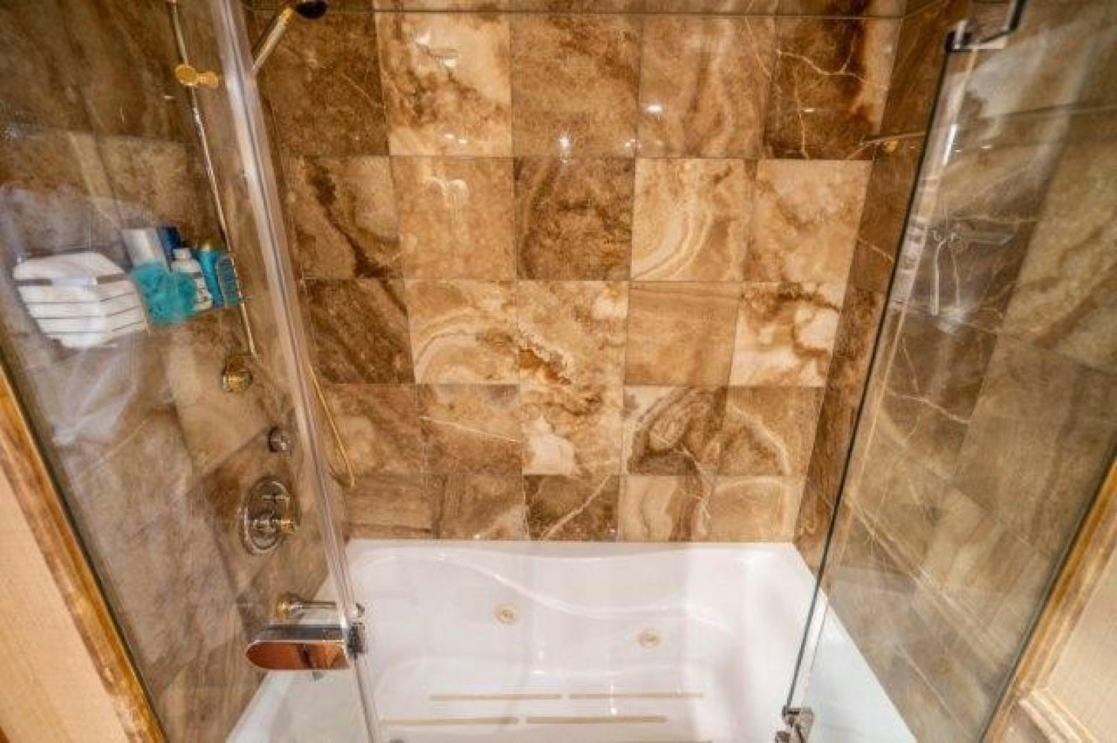 a bathroom with a bathtub and shower aboard CENTODUE Yacht for Sale