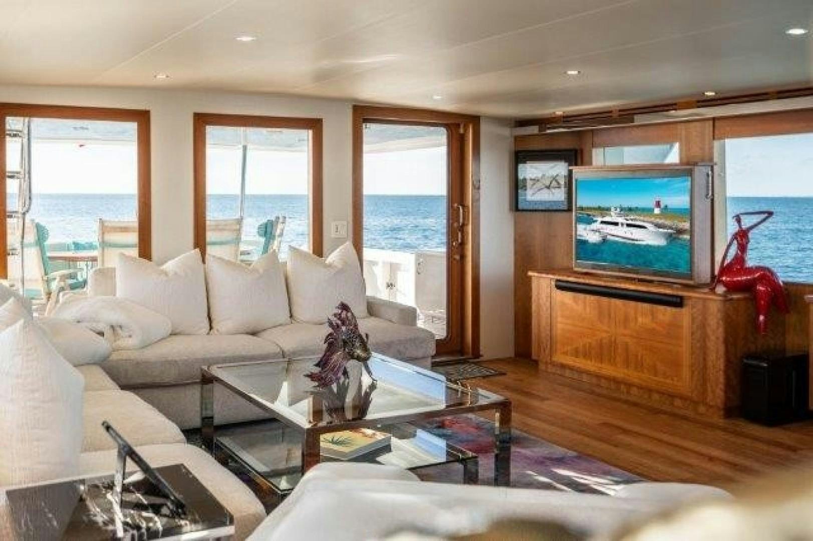 a living room with a large television aboard CENTODUE Yacht for Sale