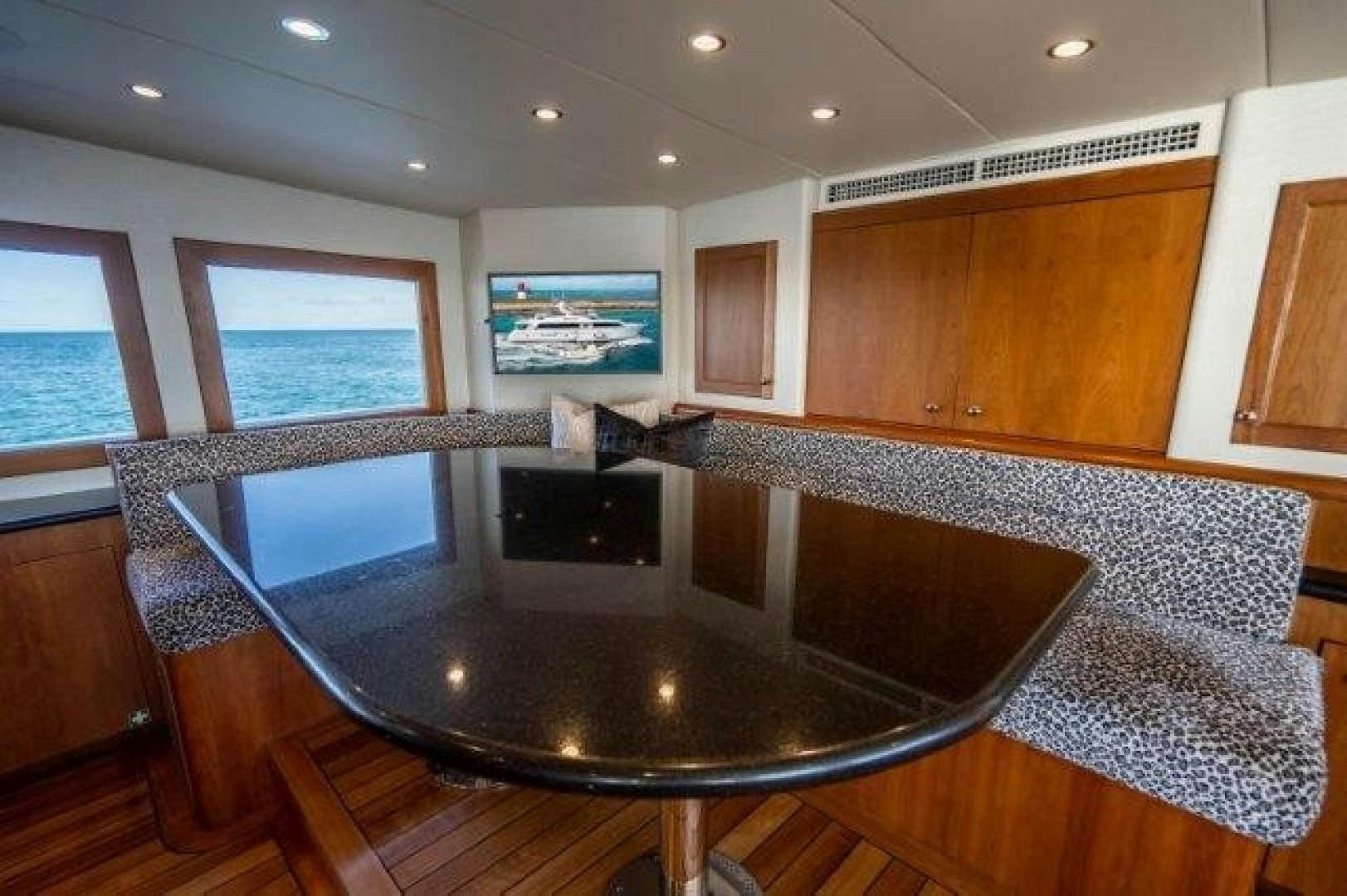 a large kitchen with a large black table and a large window aboard CENTODUE Yacht for Sale