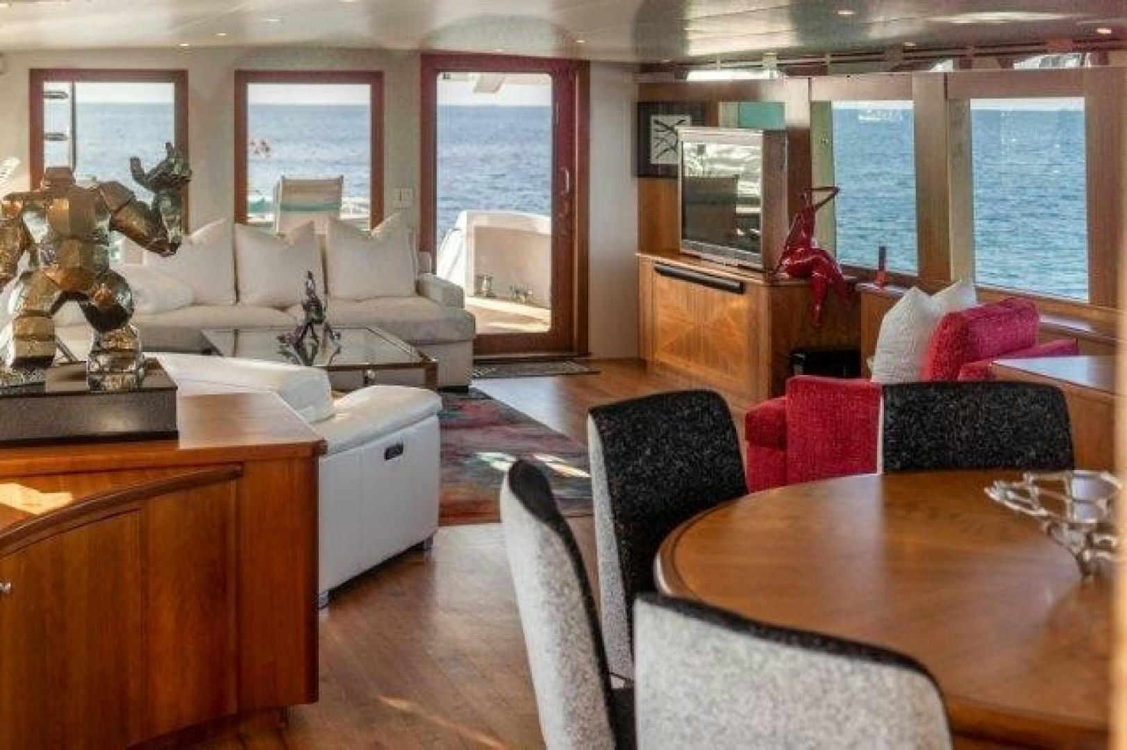 a living room with a large window aboard CENTODUE Yacht for Sale