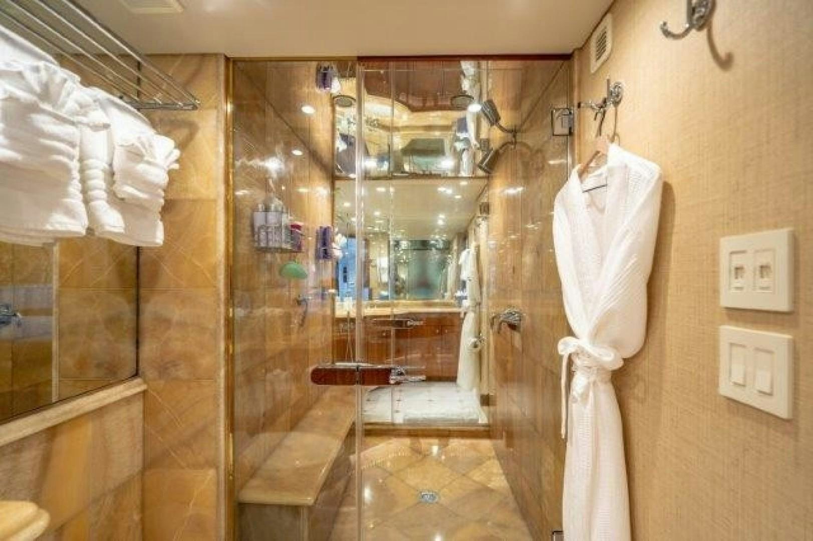 a bathroom with a robe on the wall aboard CENTODUE Yacht for Sale
