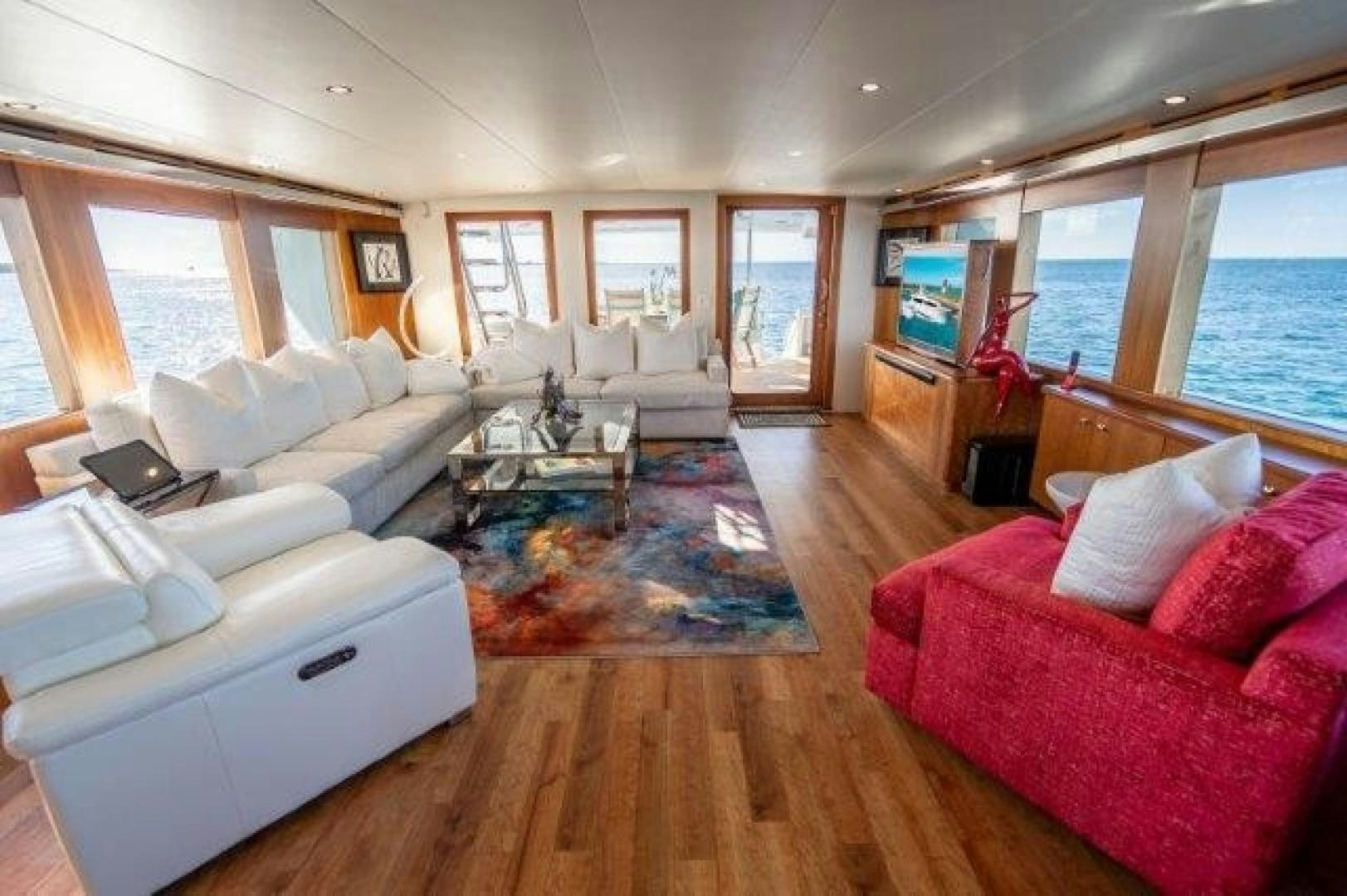 a living room with a large window aboard CENTODUE Yacht for Sale