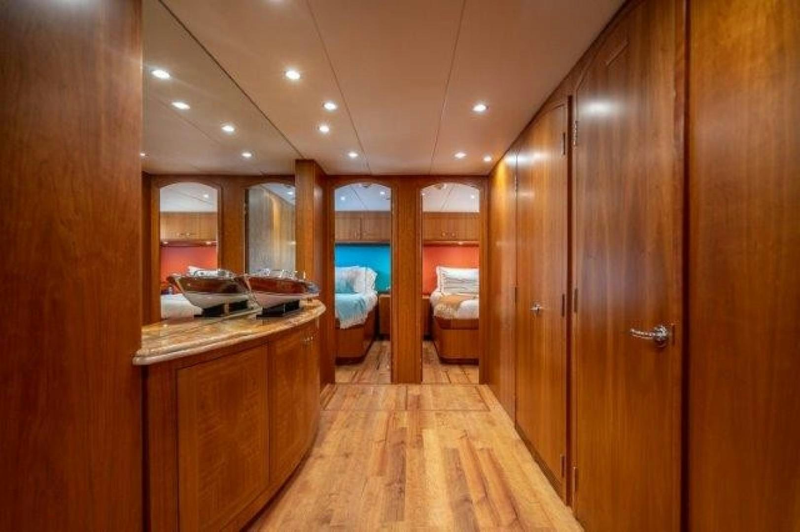 a room with wooden cabinets and a wood floor aboard CENTODUE Yacht for Sale