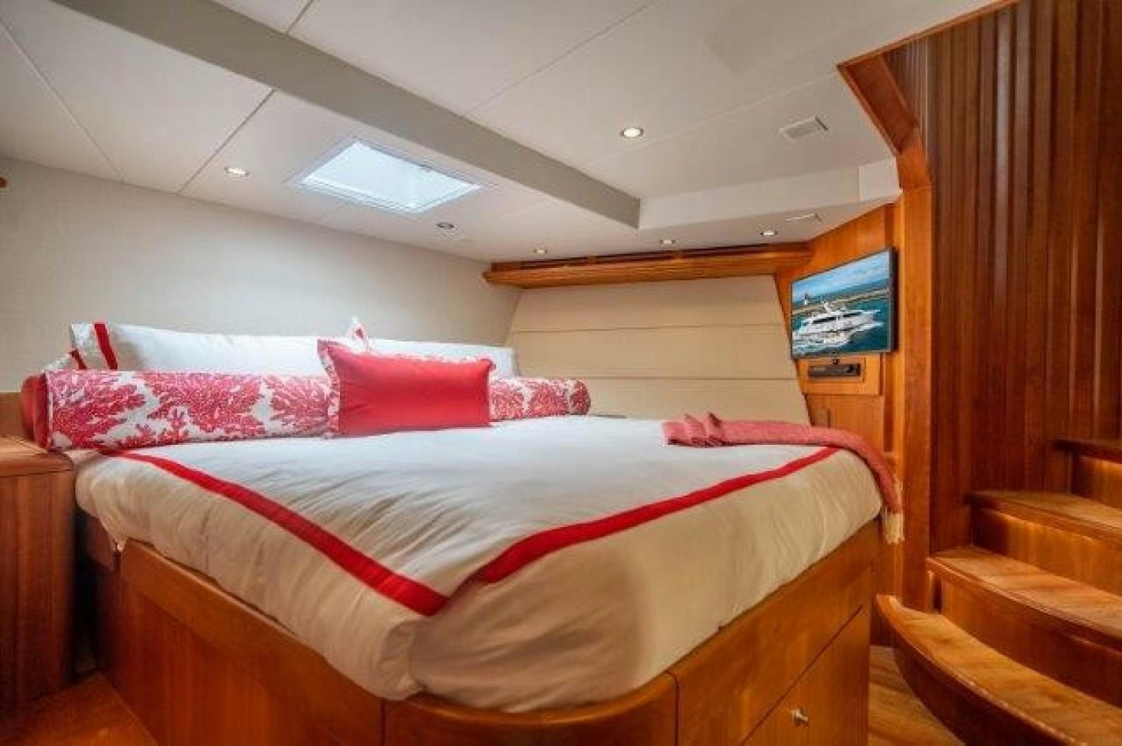 a bed with red pillows aboard CENTODUE Yacht for Sale
