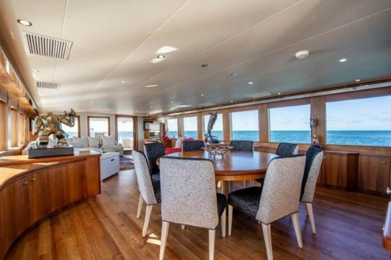 a large dining table in a room aboard CENTODUE Yacht for Sale
