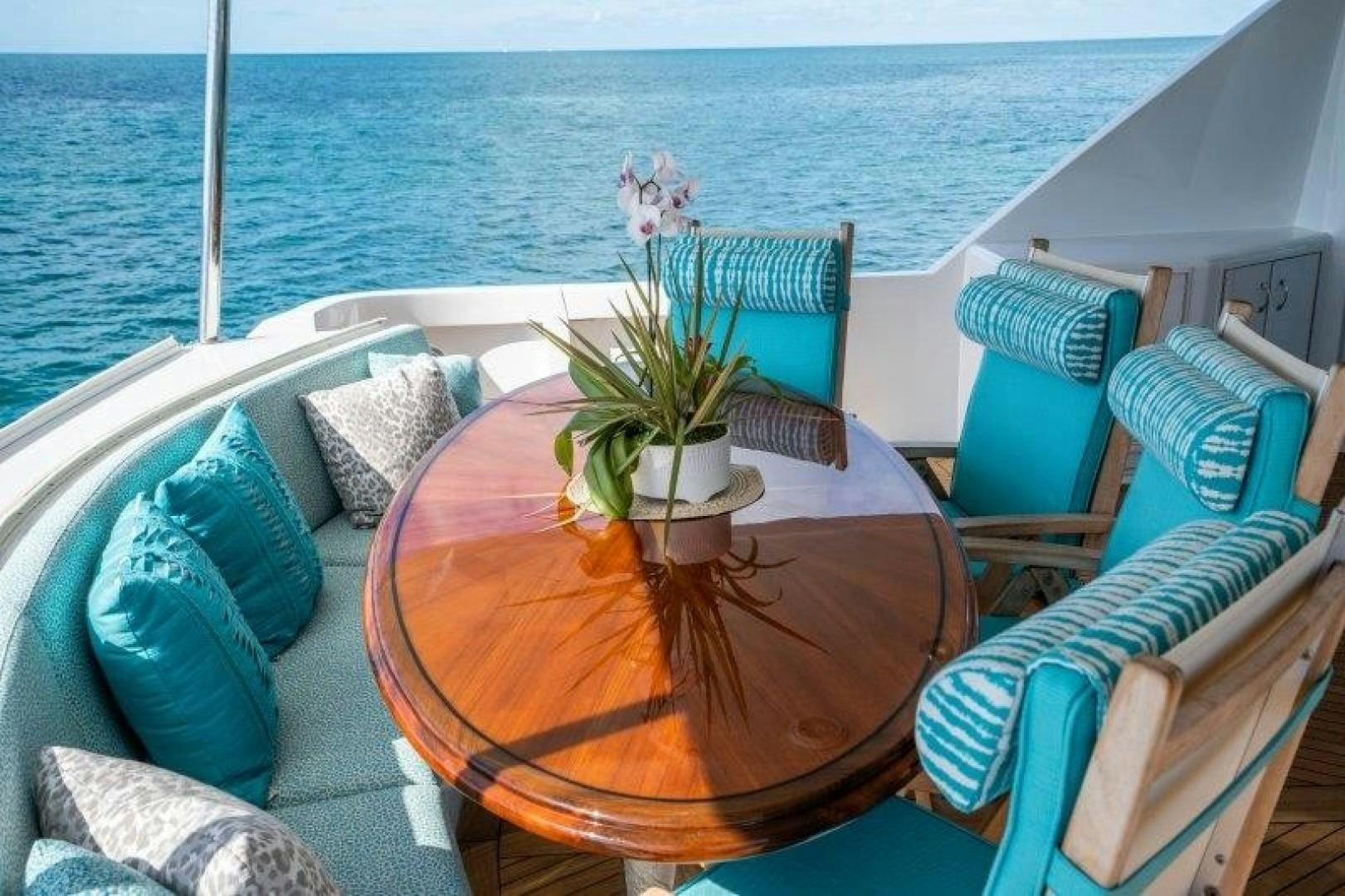 a table with chairs and plants on it aboard CENTODUE Yacht for Sale
