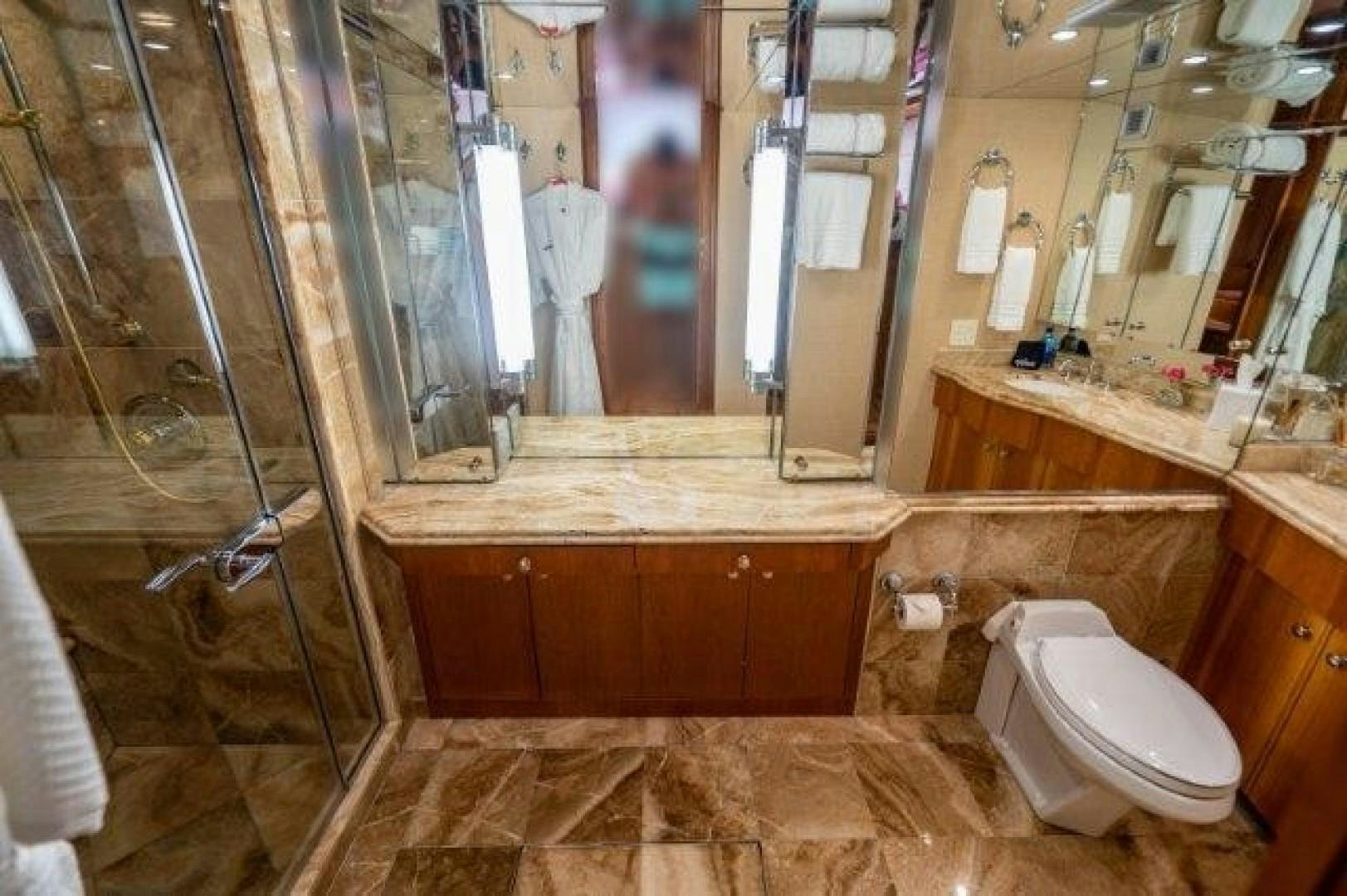 a bathroom with a glass shower aboard CENTODUE Yacht for Sale
