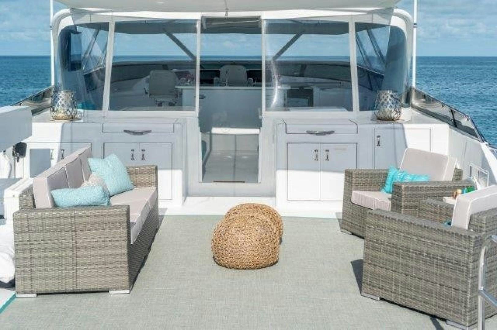 a room with a couch and a chair and a large body of water aboard CENTODUE Yacht for Sale