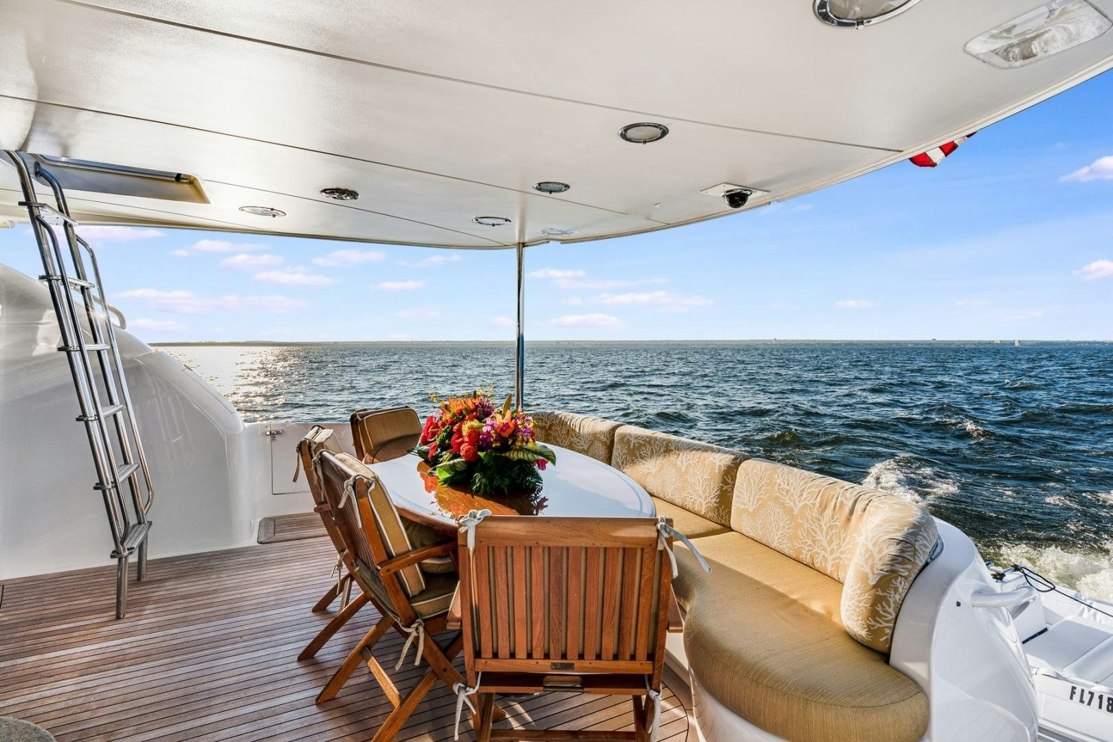 a table and chairs on a deck overlooking the ocean aboard SUMMERWIND Yacht for Sale