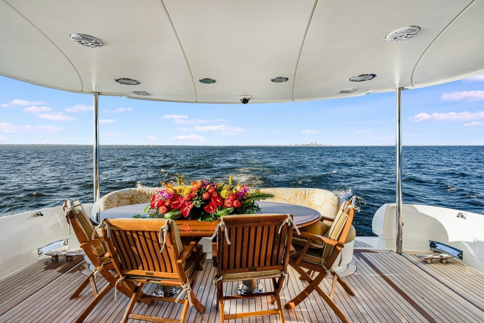 a table and chairs on a deck overlooking the ocean aboard SUMMERWIND Yacht for Sale