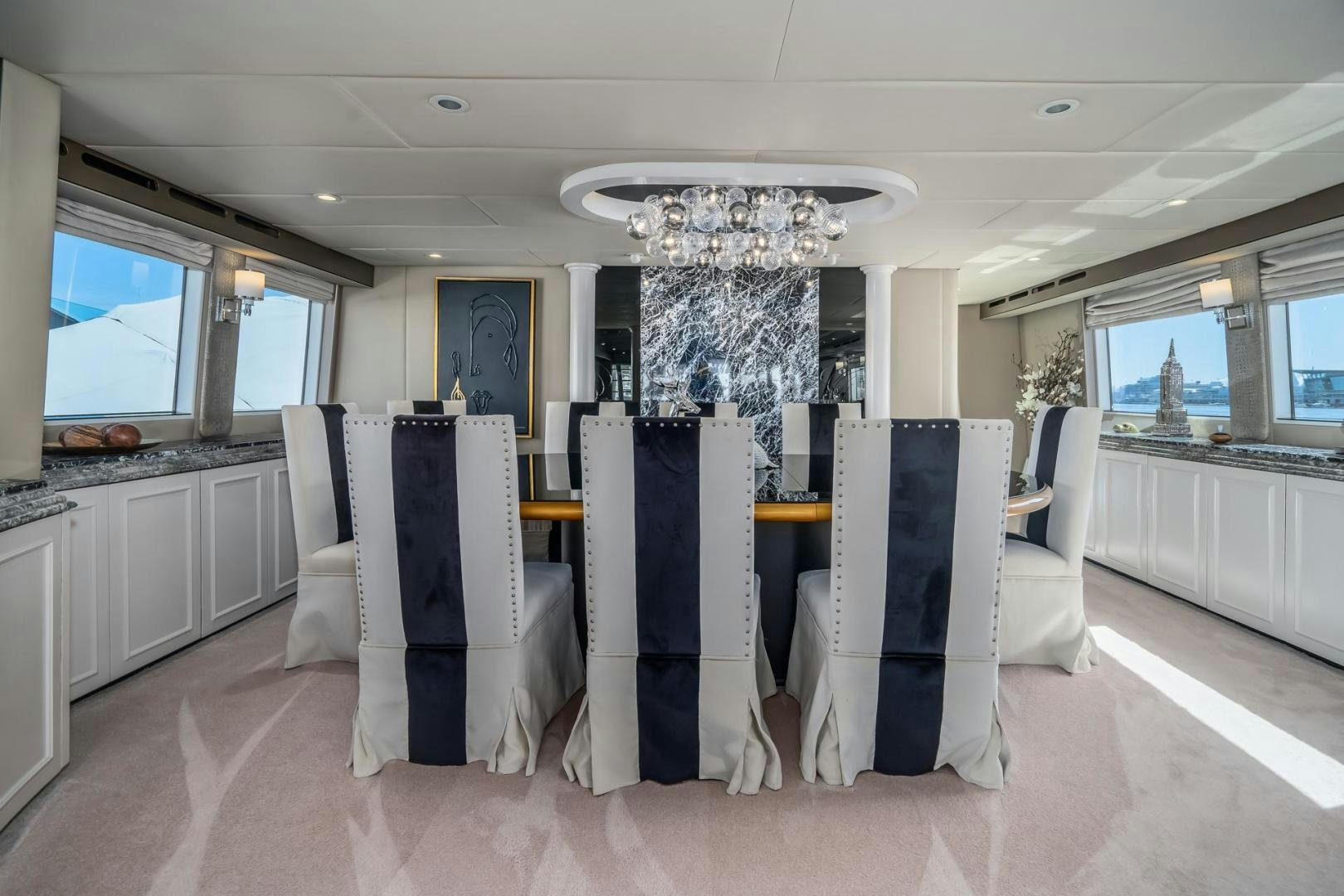 a large room with chairs and a table aboard SOVEREIGN LADY Yacht for Sale