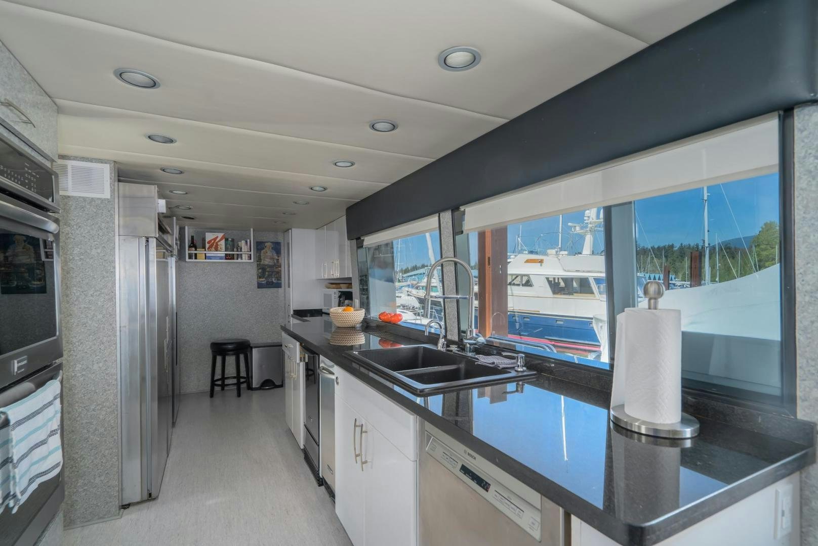 a kitchen with a large window aboard SOVEREIGN LADY Yacht for Sale
