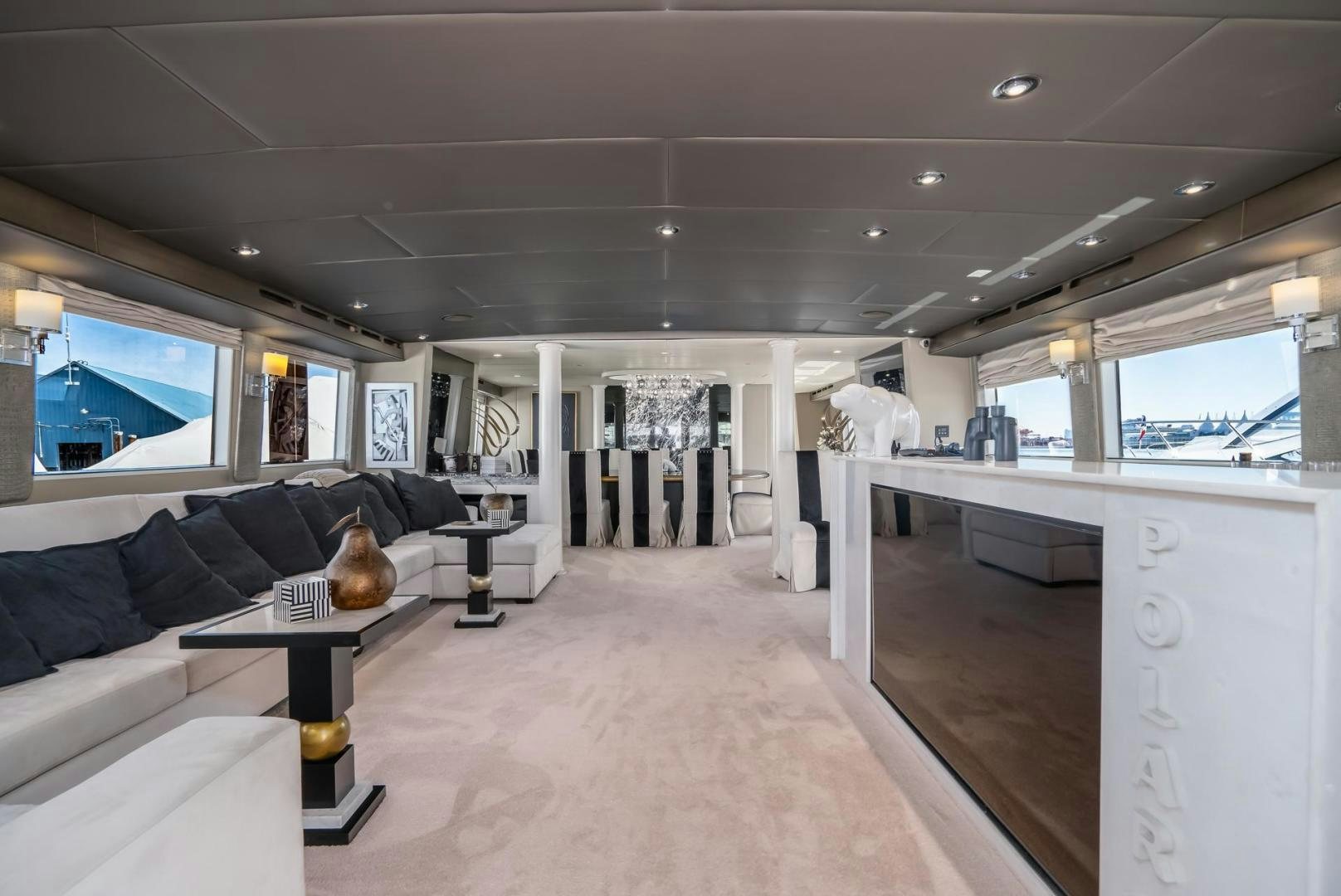 a living room with a large window aboard SOVEREIGN LADY Yacht for Sale