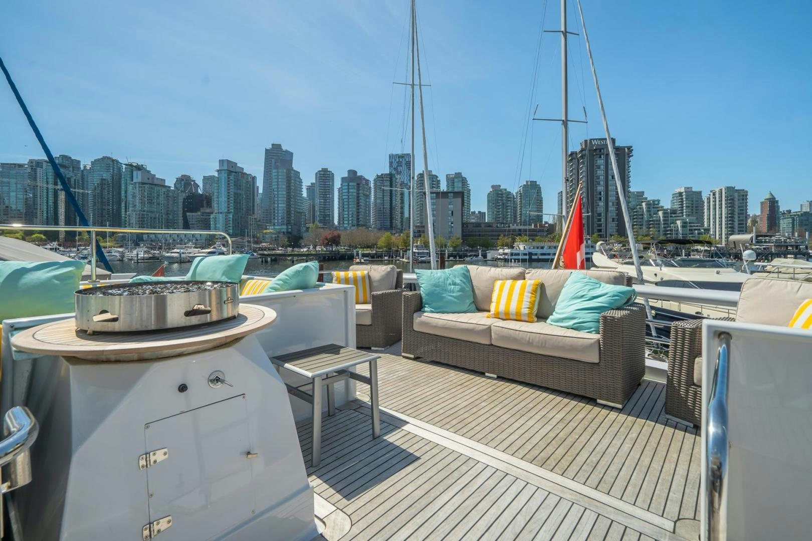a deck with a couch and a city in the background aboard SOVEREIGN LADY Yacht for Sale