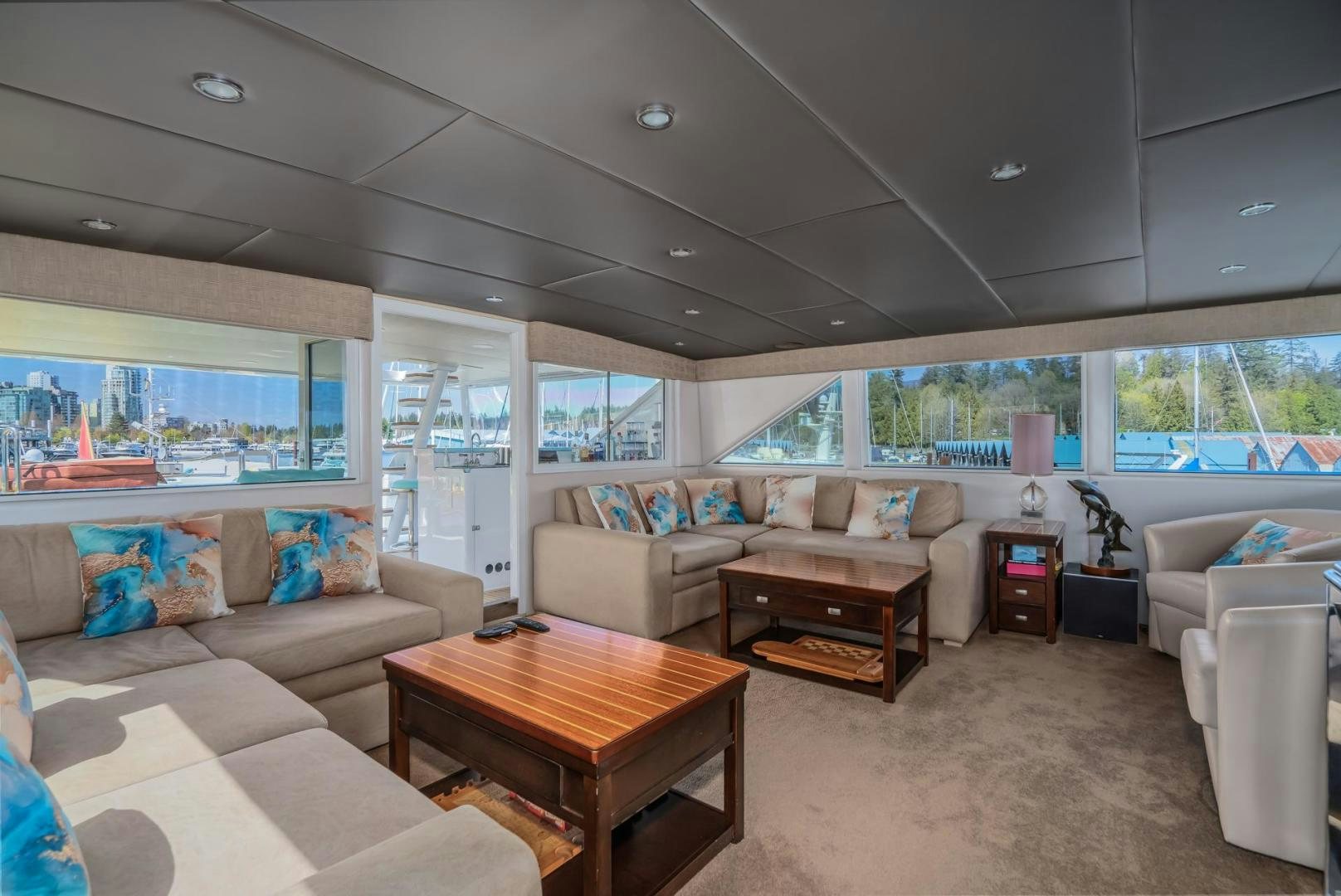 a living room with a large window aboard SOVEREIGN LADY Yacht for Sale