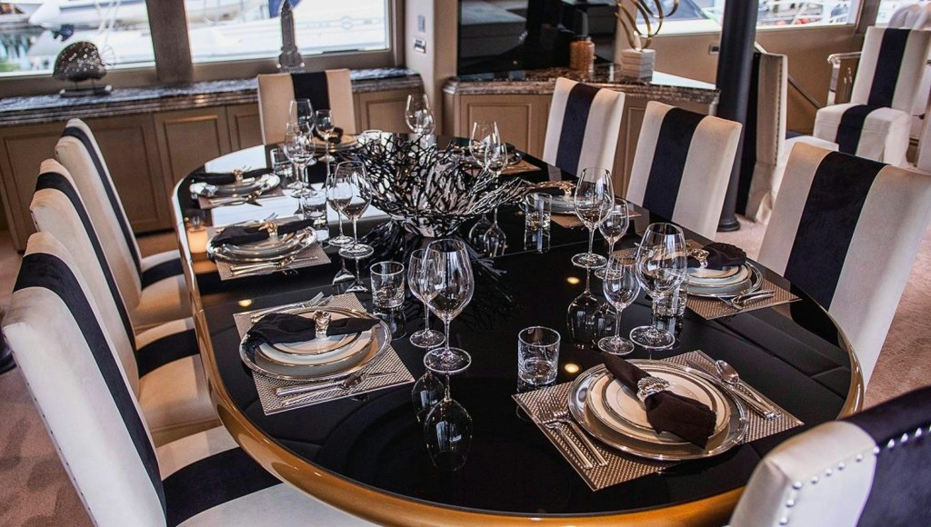 a table set with plates and glasses aboard SOVEREIGN LADY Yacht for Sale
