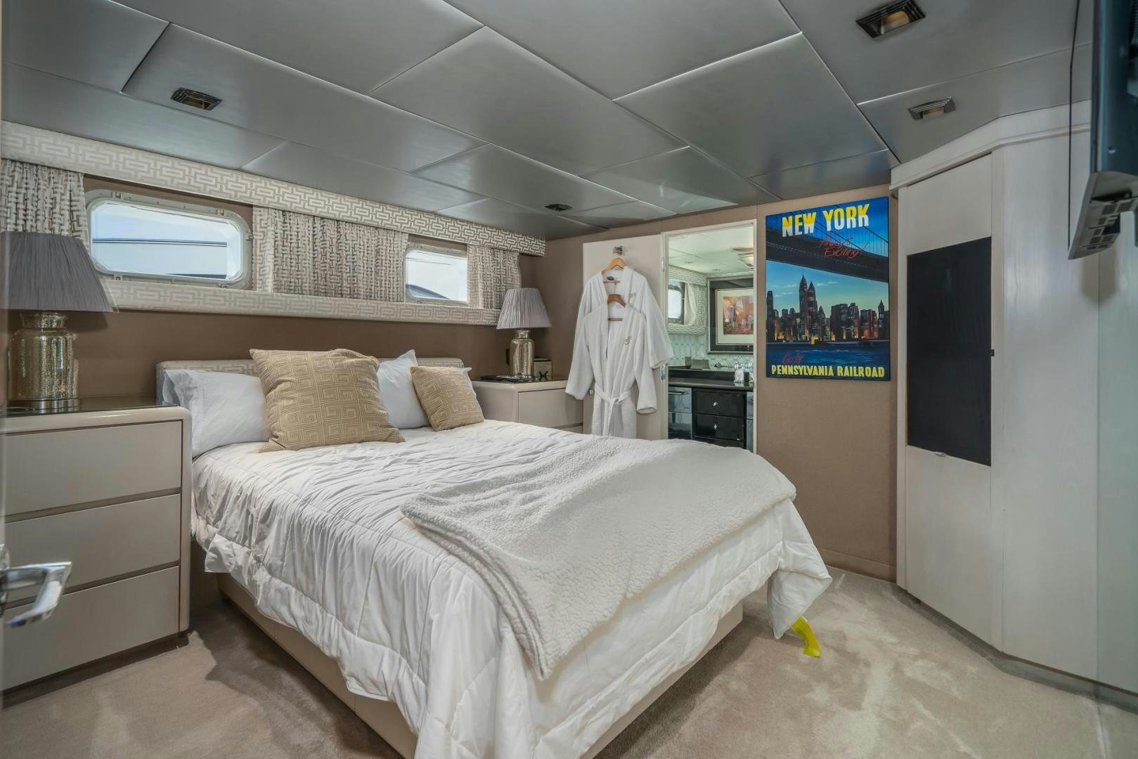 a bedroom with a bed and a television aboard SOVEREIGN LADY Yacht for Sale