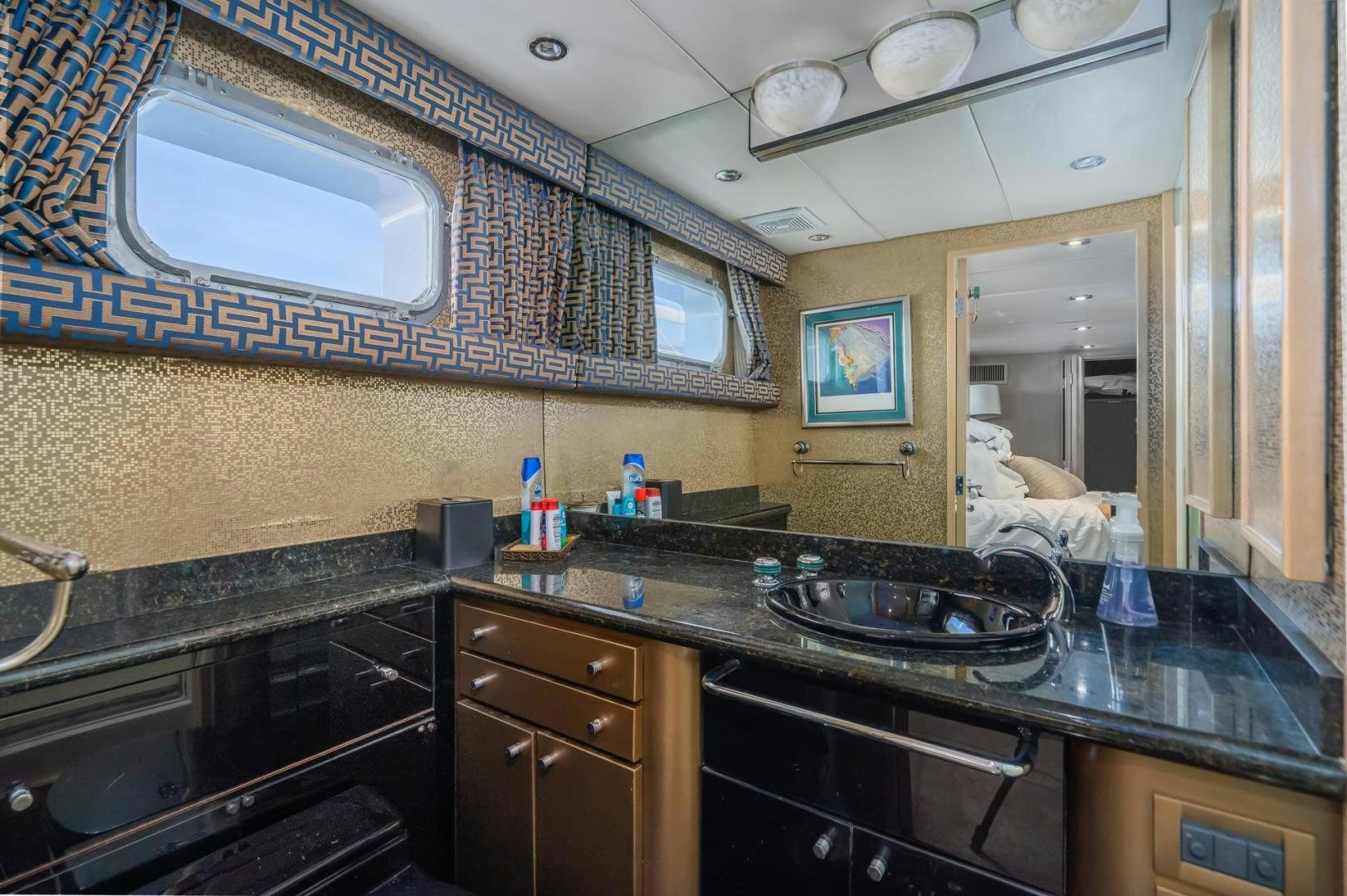 a kitchen with a sink and a mirror aboard SOVEREIGN LADY Yacht for Sale
