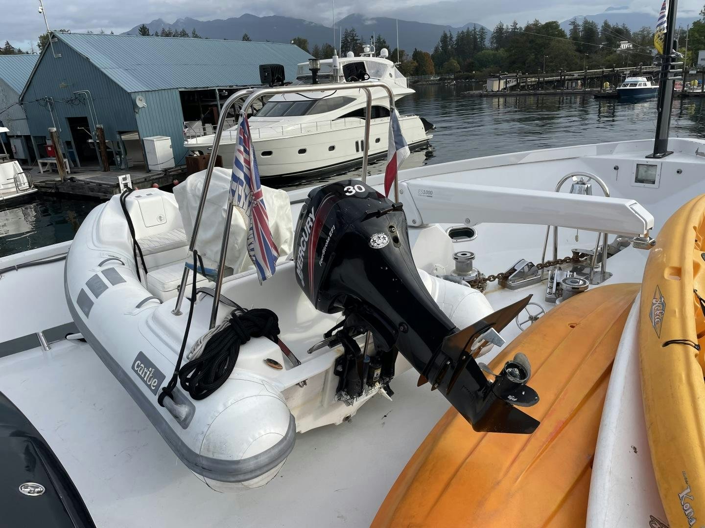 a boat with a motor and a flag on the front aboard SOVEREIGN LADY Yacht for Sale