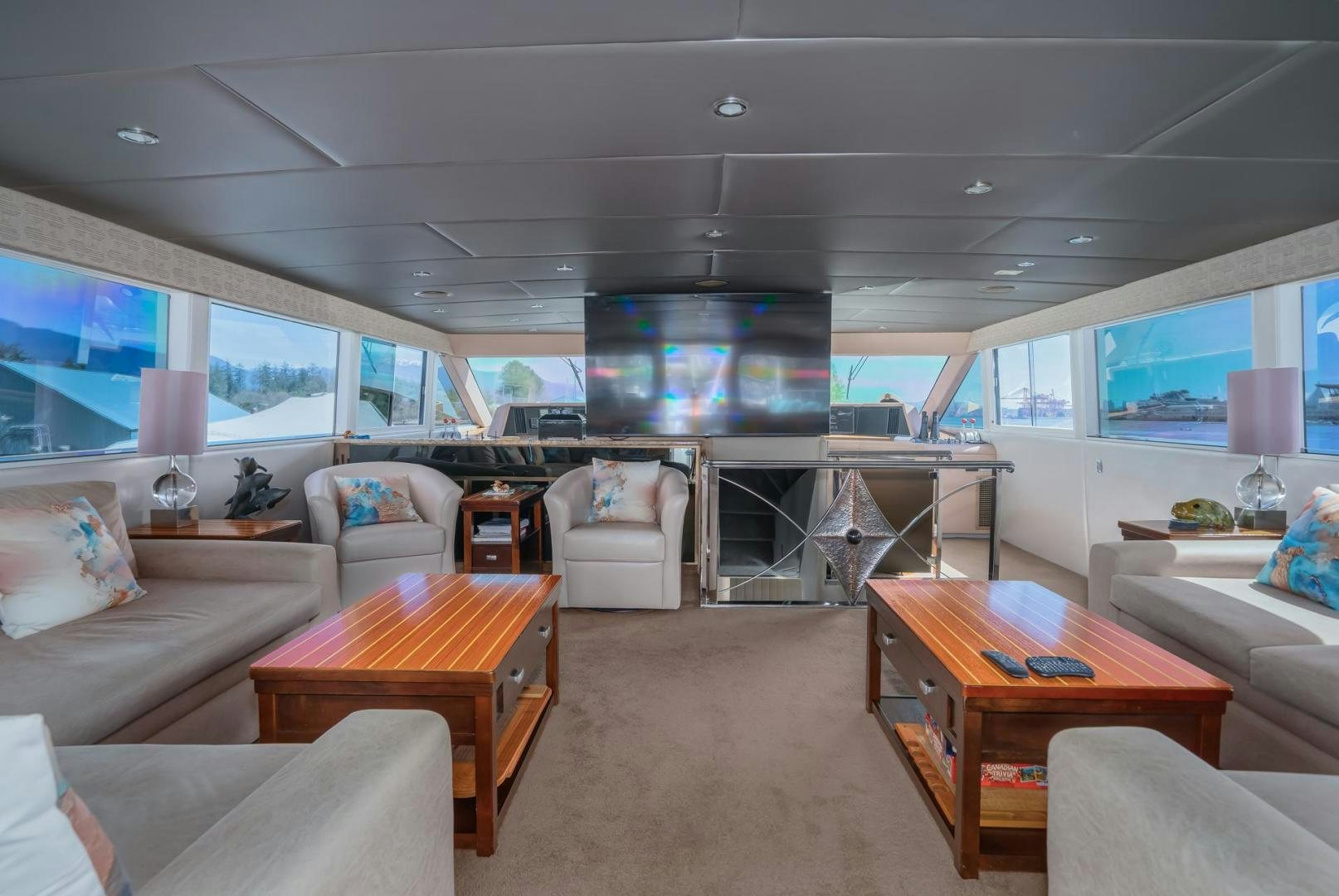 a living room with a large window aboard SOVEREIGN LADY Yacht for Sale