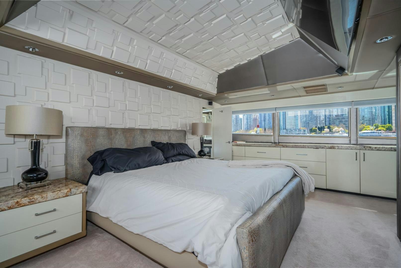 a bedroom with a large bed aboard SOVEREIGN LADY Yacht for Sale