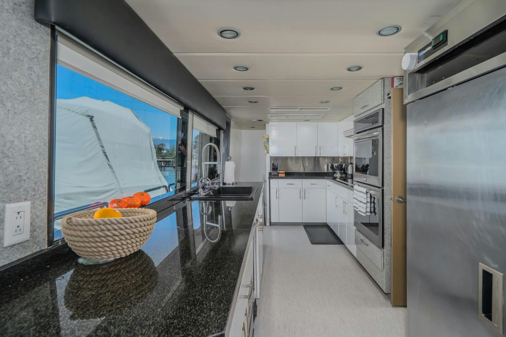 a large room with a large glass window and a large blue glass door aboard SOVEREIGN LADY Yacht for Sale