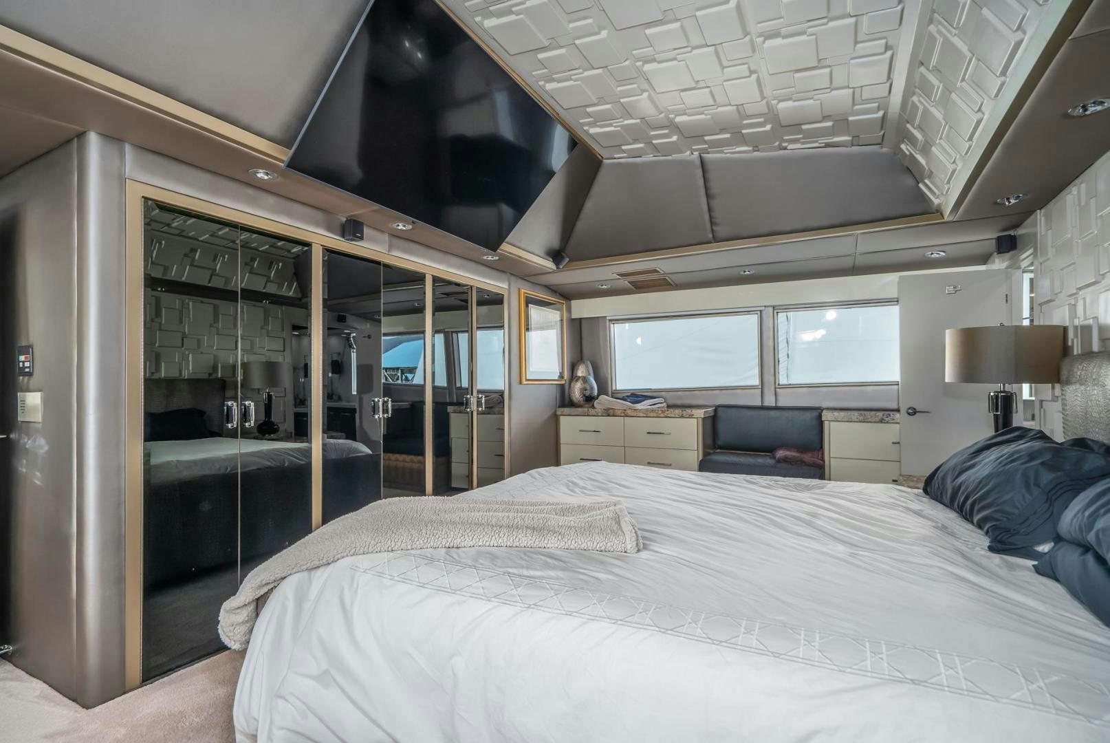 a room with a bed and a window aboard SOVEREIGN LADY Yacht for Sale